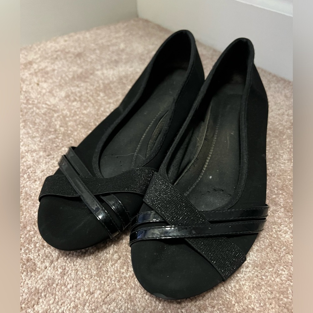 Black flats with glittery strap detailing.